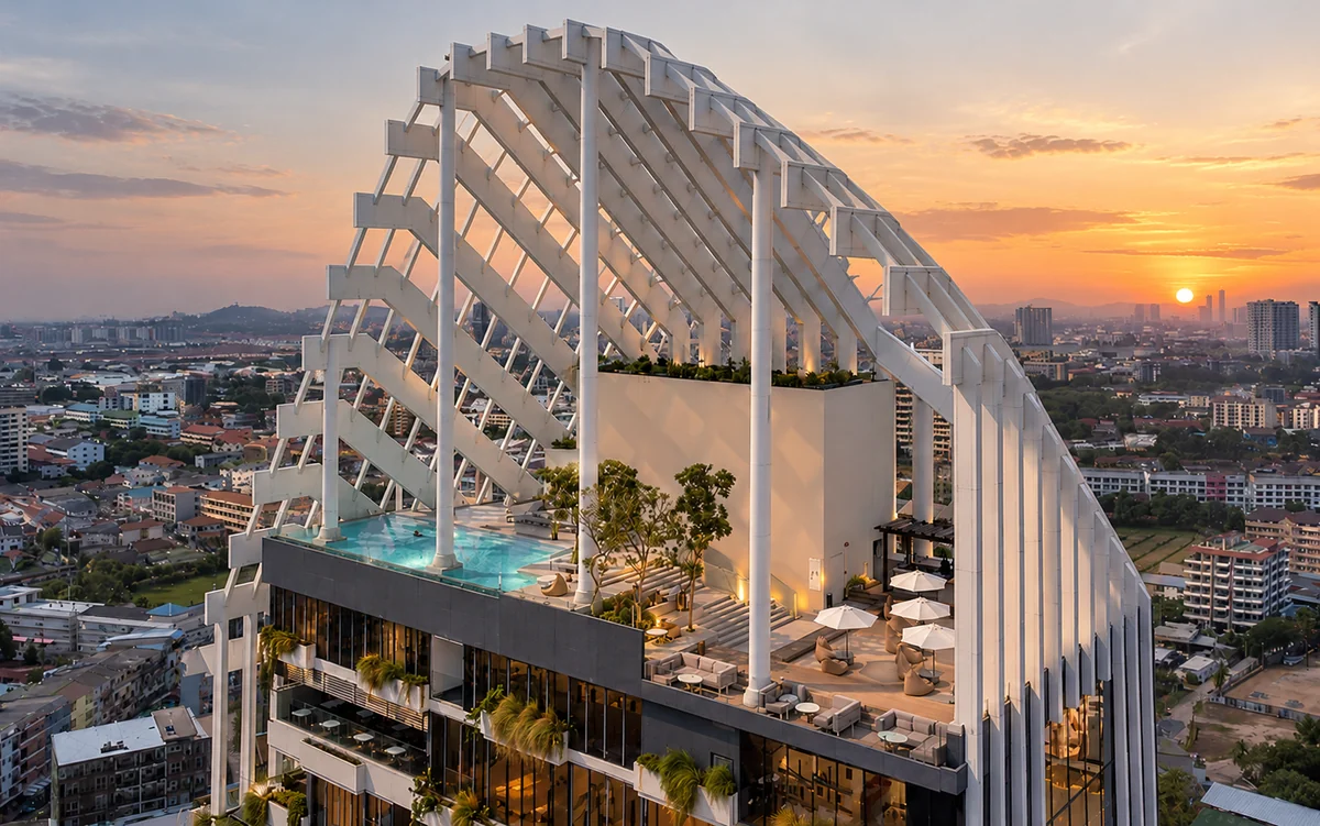 Aerial view of the rooftop of Arbour Hotel and Residence Pattaya at sunset, with infinity pool, lounge terrace and signature white roof structure